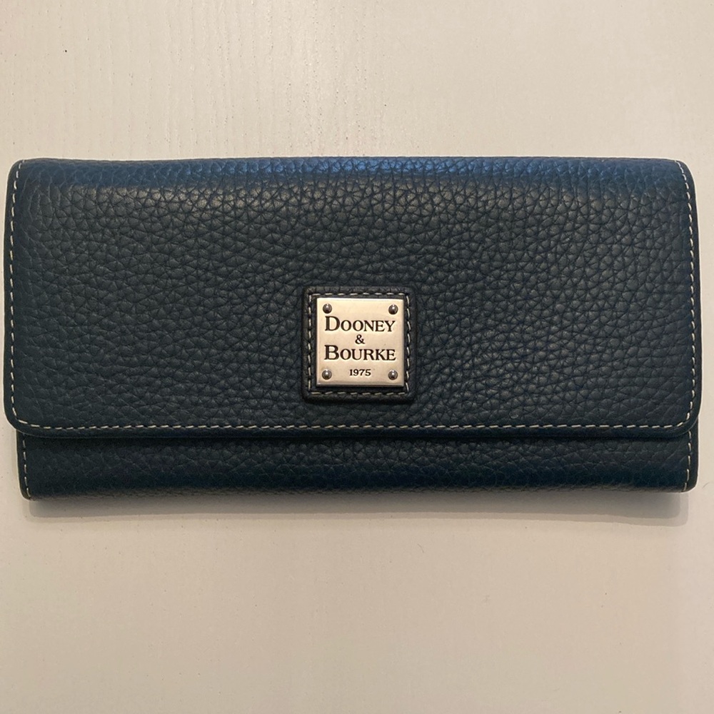 Brand new Dooney and Bourke clutch wallet in midnight blue.
